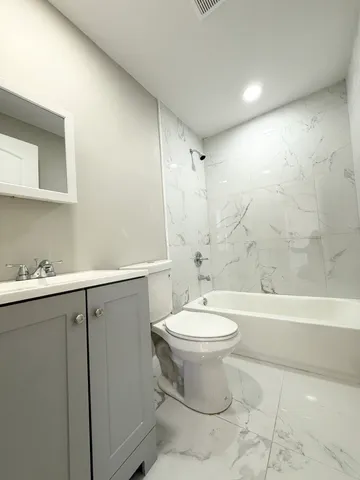 a bathroom with a sink a toilet and bathtub