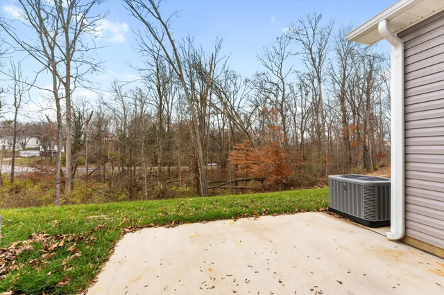 a wooden bench in middle of the yard