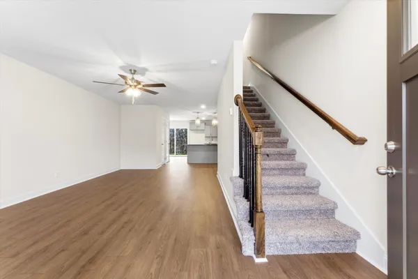 a view of entryway and hall with wooden floor