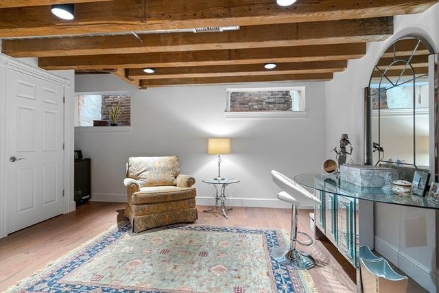 a living room with furniture and a painting on the wall
