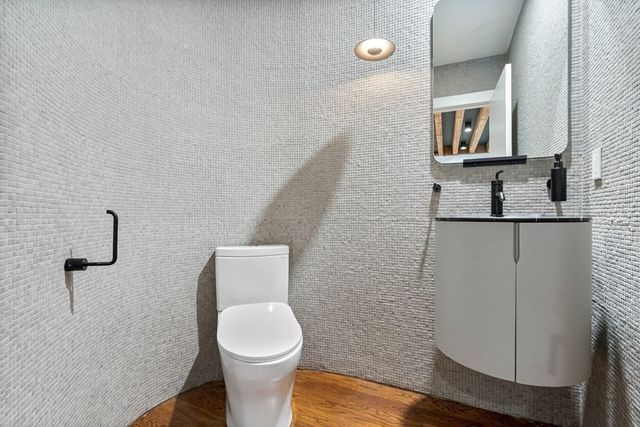 a white toilet sitting next to a bathroom sink