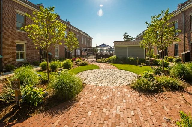a view of backyard with plants and outdoor seating