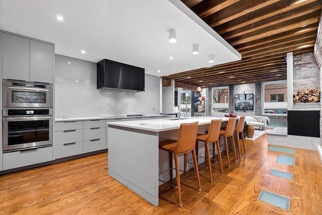 a large kitchen with lots of counter space and stainless steel appliances