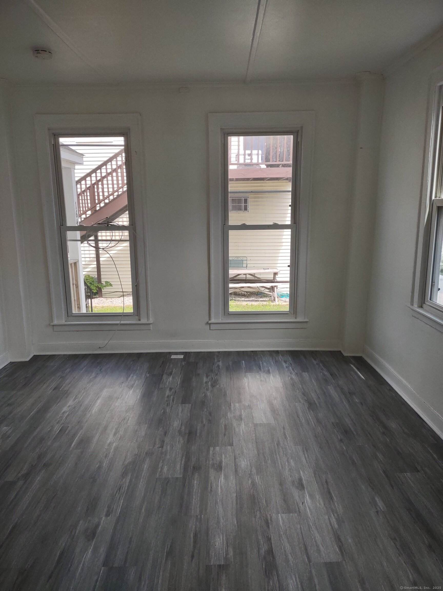 164 A Main Street, Unit A Deep River, CT 06417 - Photo 1 of 1 an empty room with wooden floor and windows