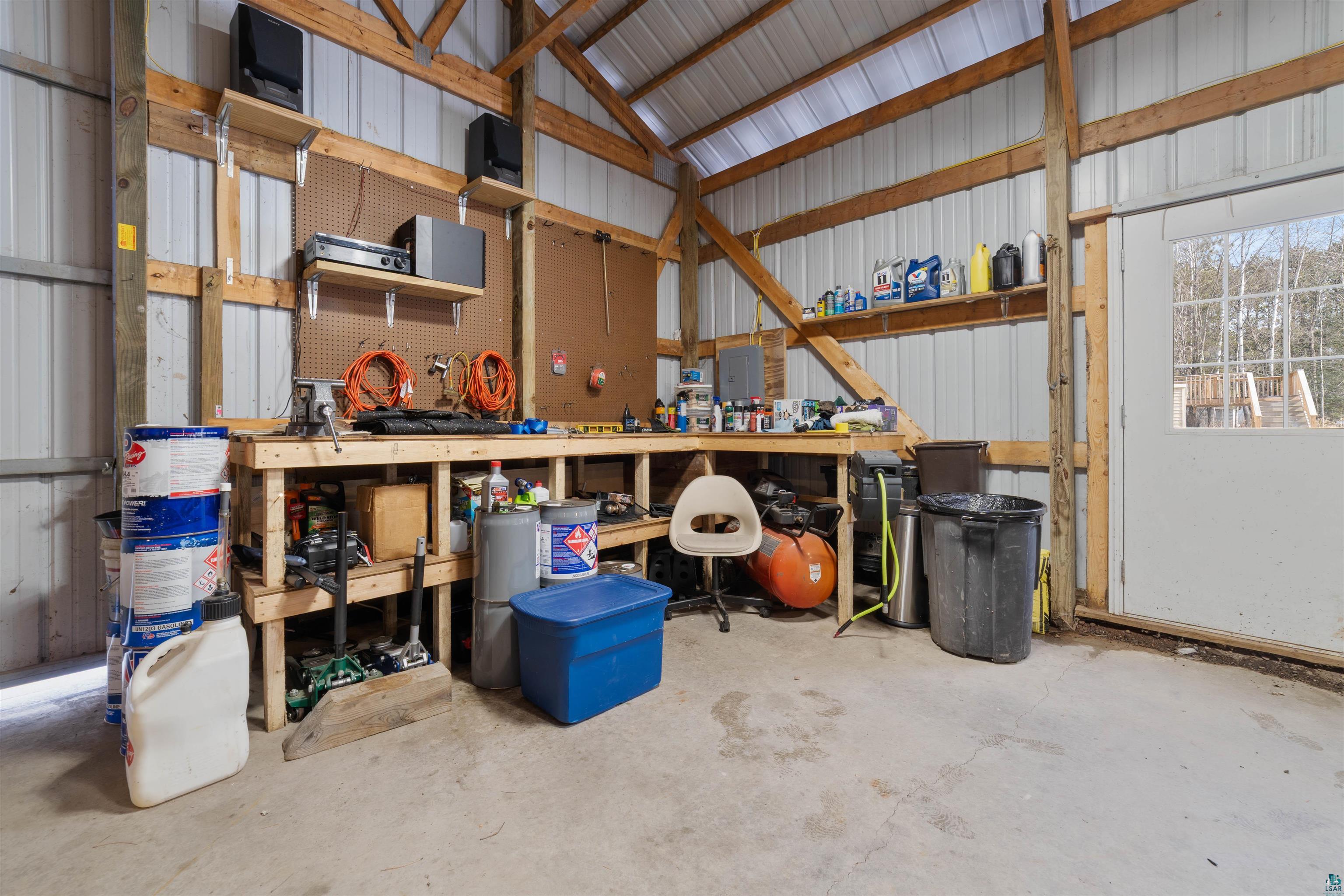 26 Riverside Road Esko, MN 55733 - Photo 34 of 34 Garage featuring a workshop area and metal wall