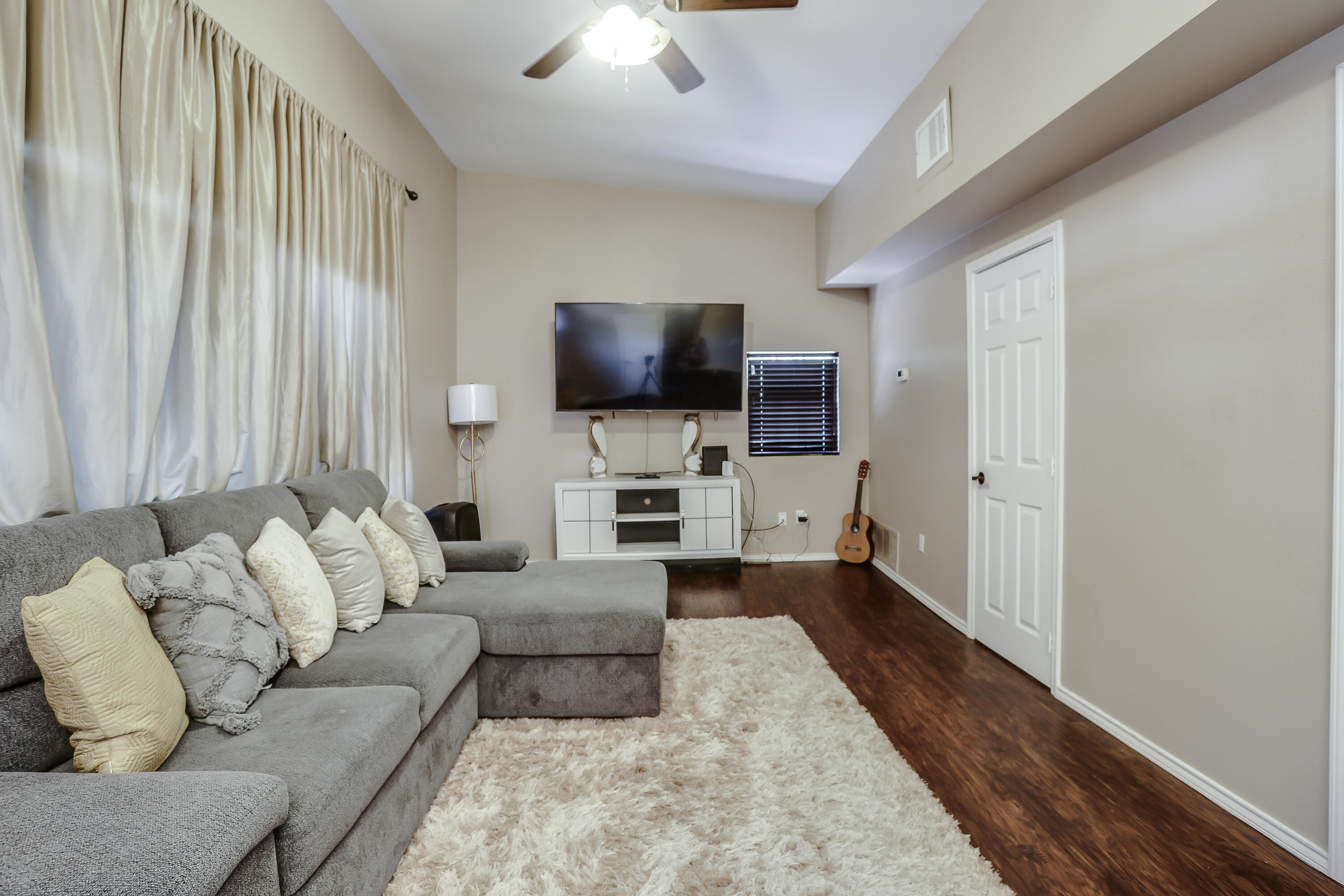 68 Pony Express Trail Lubbock, TX 79404 - Photo 5 of 15 a living room with furniture and a flat screen tv
