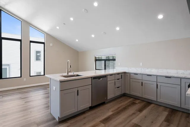 a kitchen with sink cabinets and wooden floor