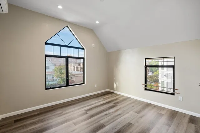 an empty room with windows and closet