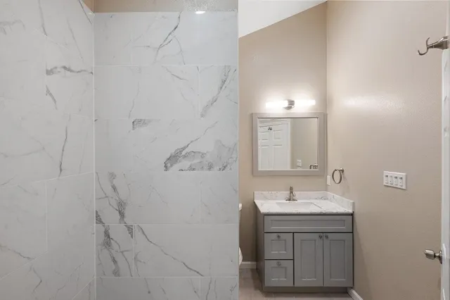 a bathroom with a sink vanity and a mirror