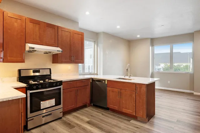 a kitchen with stainless steel appliances a stove and a sink