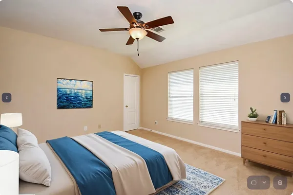 an empty room with fan and windows
