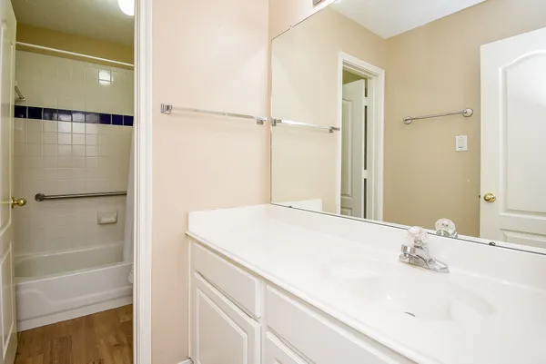 a large bathroom with a tub sink shower and mirror