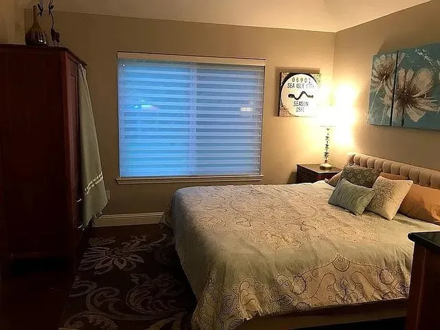 a bathroom with a granite countertop double vanity sink and mirror