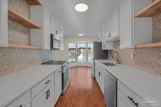 a kitchen with a sink stove and cabinets