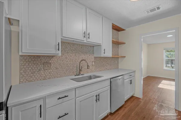 a kitchen with a sink and cabinets