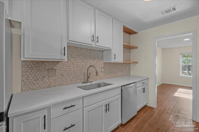 a kitchen with a sink and cabinets