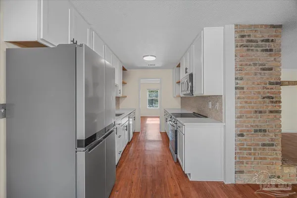 a kitchen with stainless steel appliances a refrigerator and a stove