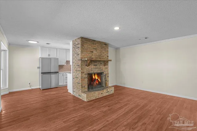 a view of a room with a fireplace wooden floor and window