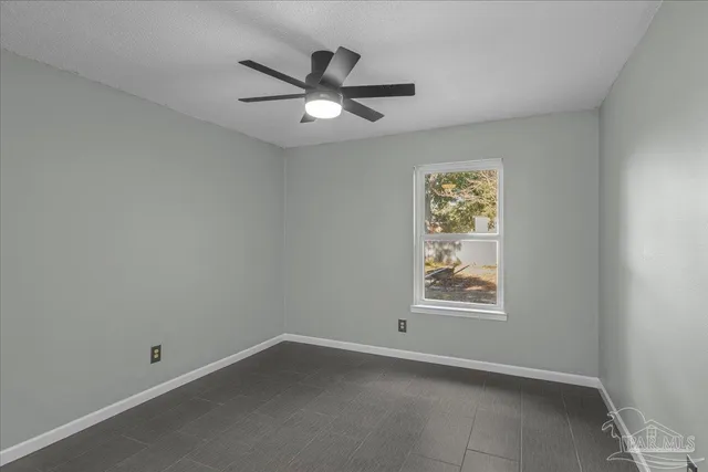 an empty room with a empty space and a ceiling fan