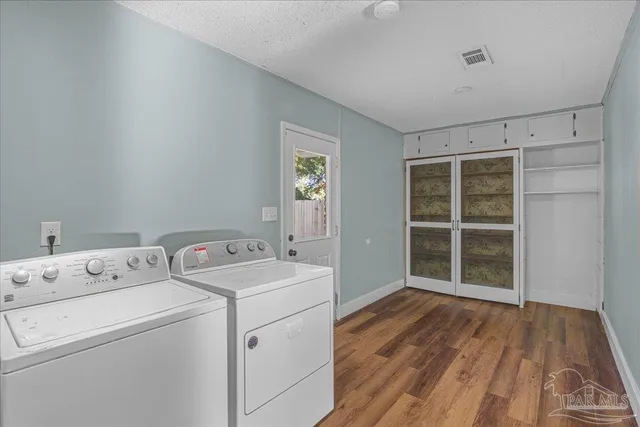 a view of a room with wooden floor and a sink