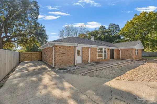 a view of a house with backyard and sitting area