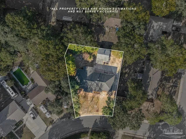 an aerial view of a houses with a yard