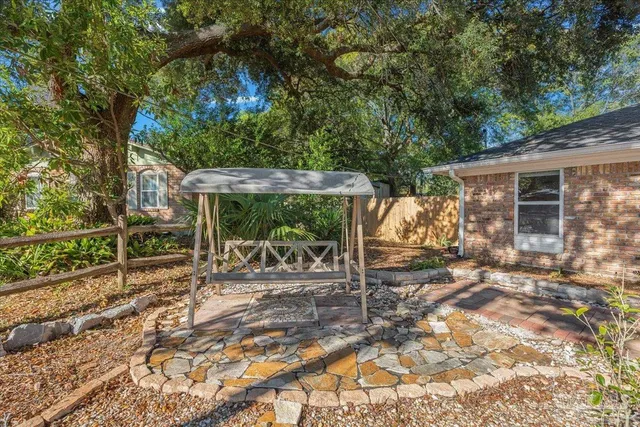 a view of a house with backyard porch and furniture