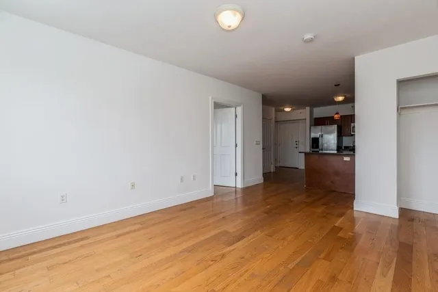a view of a kitchen with a sink and a refrigerator