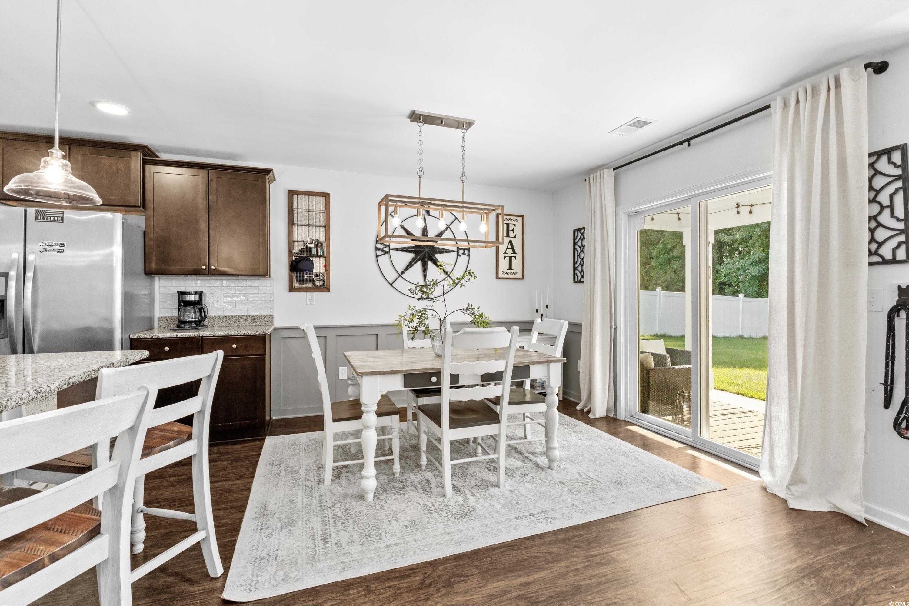 3168 Holly Loop Conway, SC 29527 - Photo 9 of 40 Dining area with a notable chandelier and dark woo