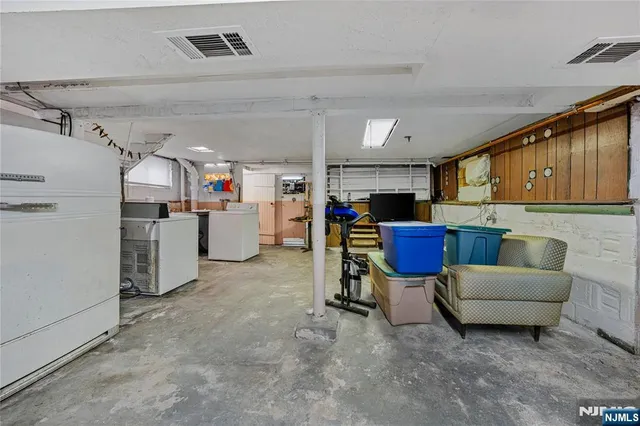 a work place with cabinets and refrigerator