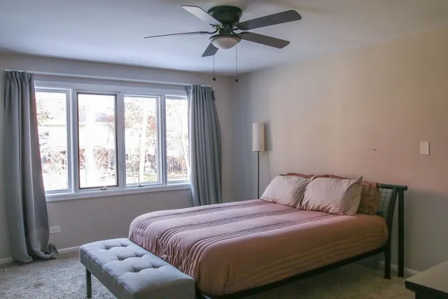 a bedroom with a bed and a window