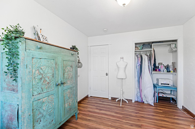 814 Mountain Road Logan, UT 84321 - Photo 18 of 42 Light-filled room featuring wood-finish flooring, white walls, and a built-in closet with shelving and hanging space