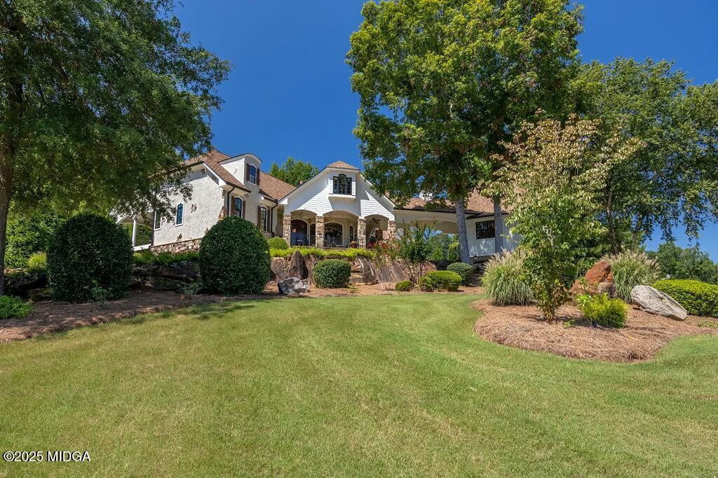 601 River Overlook Forsyth, GA 31029 - Photo 1 of 85 a front view of a house with a garden