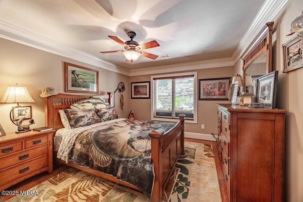 601 River Overlook Forsyth, GA 31029 - Photo 60 of 85 a bedroom with a bed and a chandelier