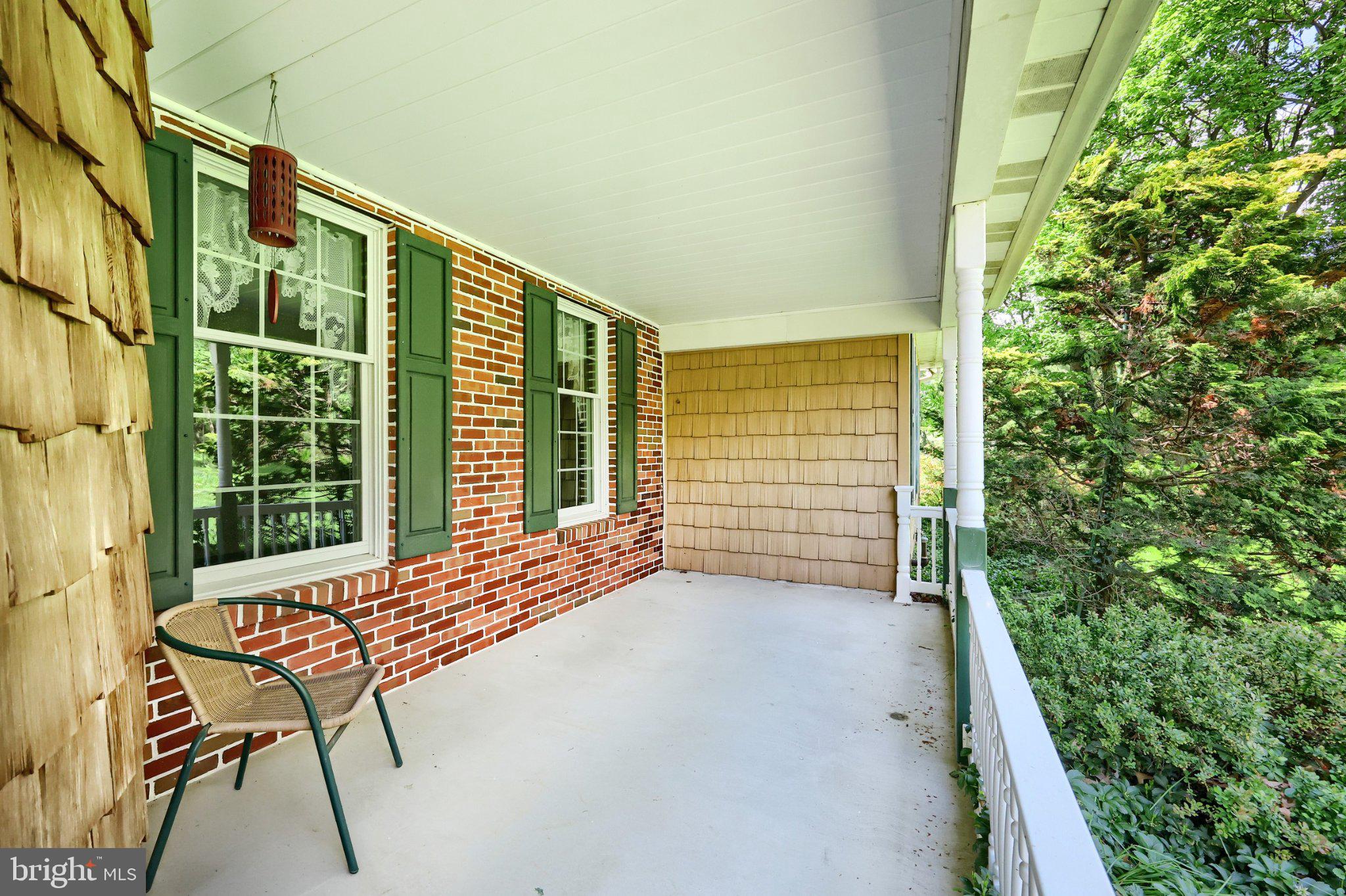 1974 Yingling Drive Spring Grove, PA 17362 - Photo 7 of 69 Charming porch with lush greenery.