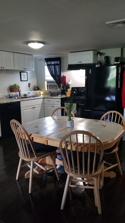15 Royal Street Springfield, MA 01109 - Photo 3 of 21 a kitchen with a table chairs and a kitchen view