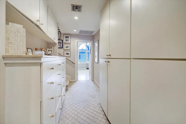 a kitchen with cabinets and a refrigerator