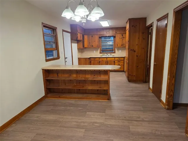 a view of kitchen with granite countertop cabinets and refrigerator