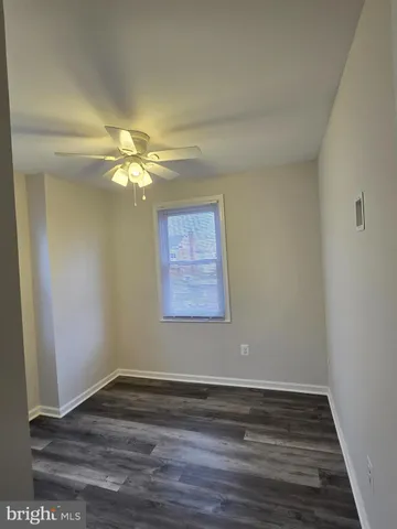 a view of room with window and hardwood floor