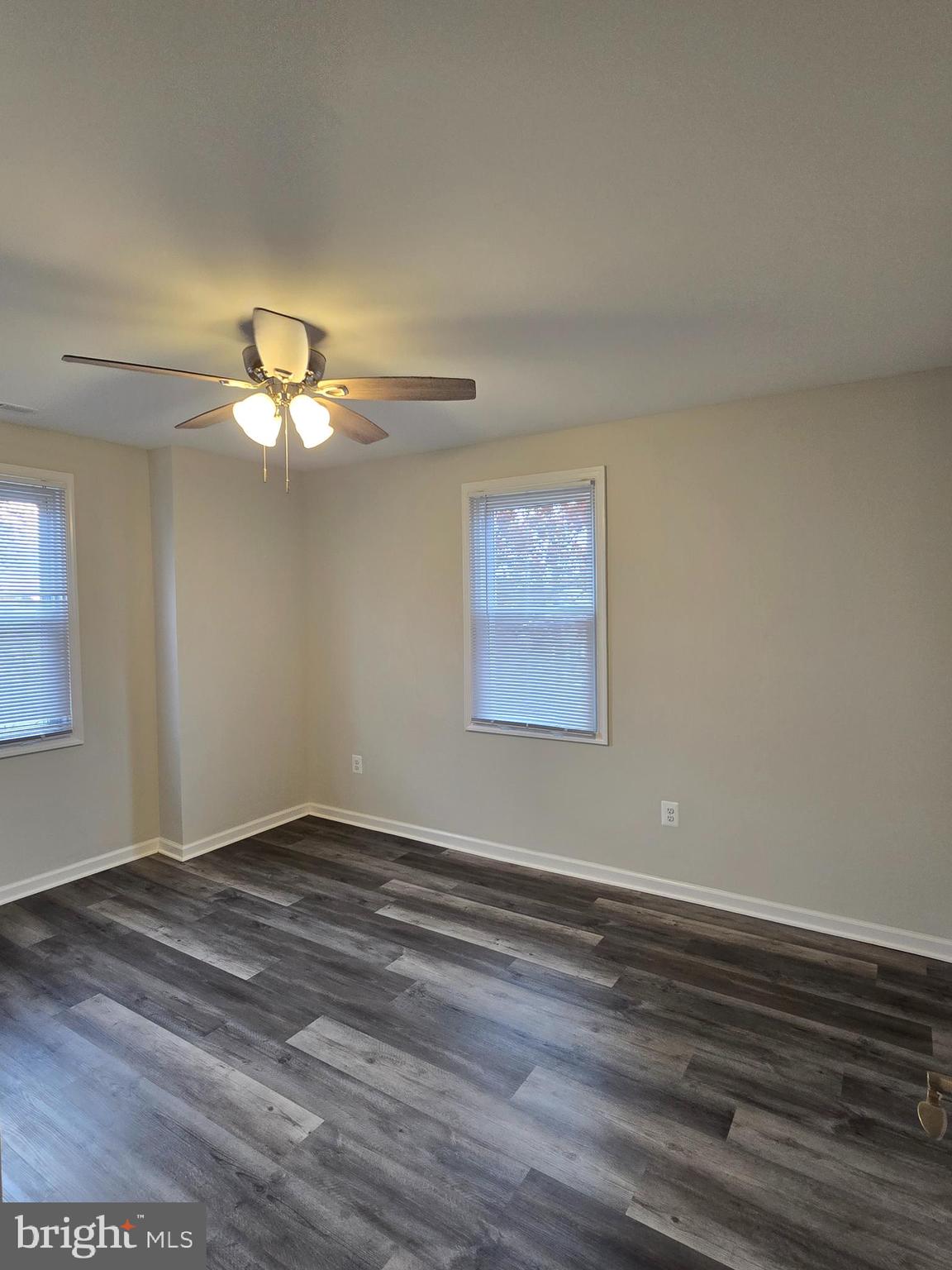 3015 Ritchie Avenue Baltimore, MD 21219 - Photo 11 of 17 a view of an empty room with wooden floor and a window