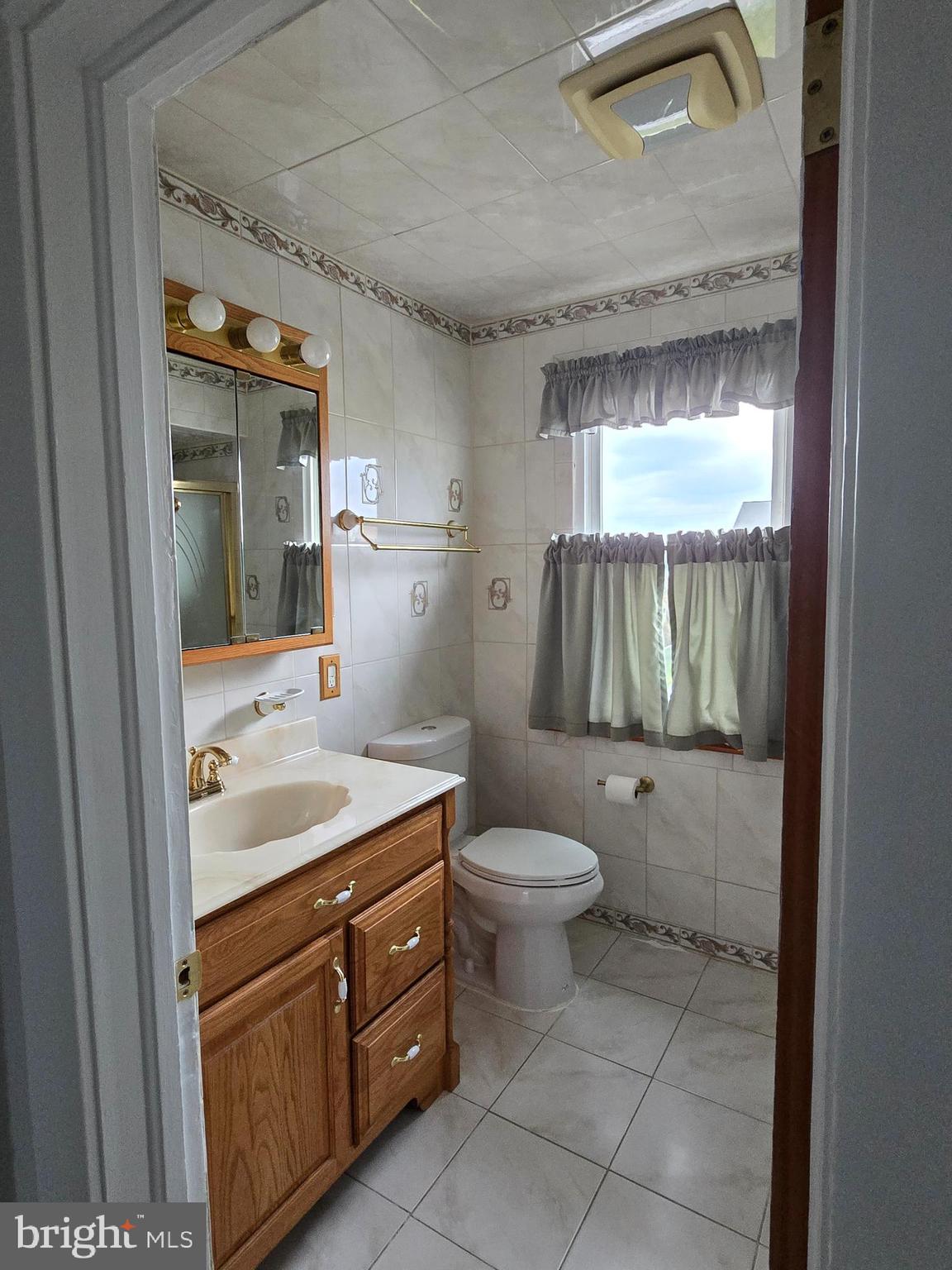 3015 Ritchie Avenue Baltimore, MD 21219 - Photo 13 of 17 a bathroom with a sink a toilet and shower
