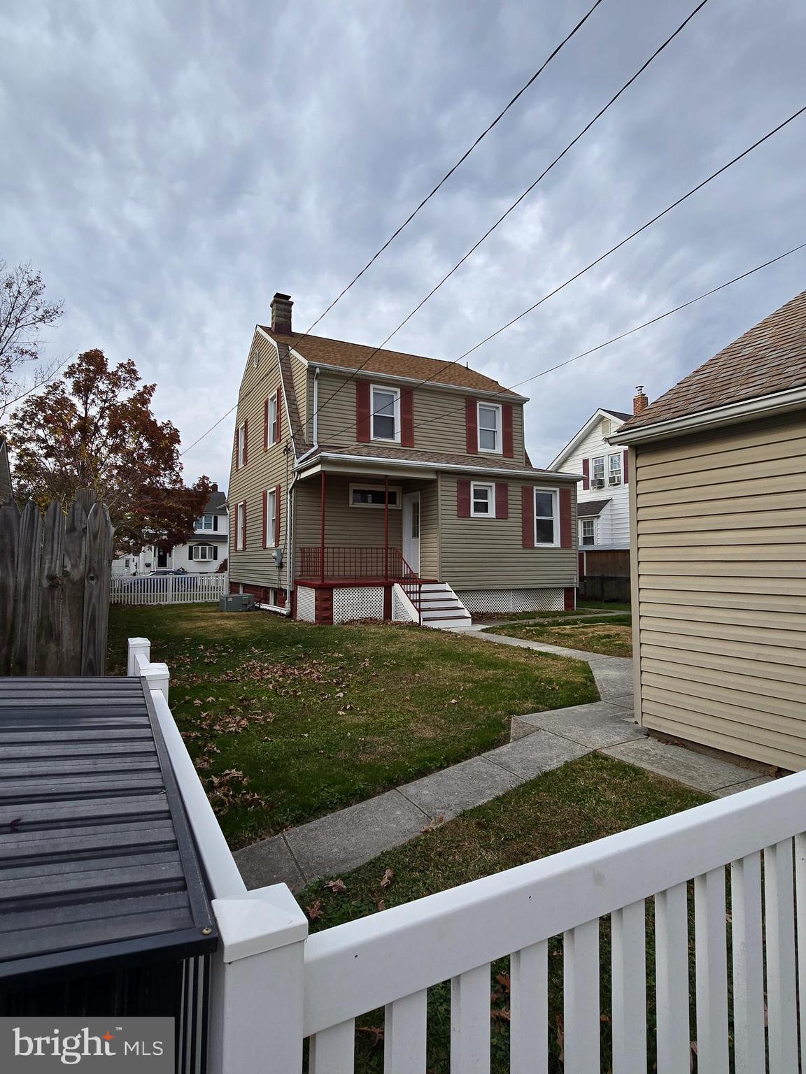 3015 Ritchie Avenue Baltimore, MD 21219 - Photo 14 of 17 a front view of a house with a yard