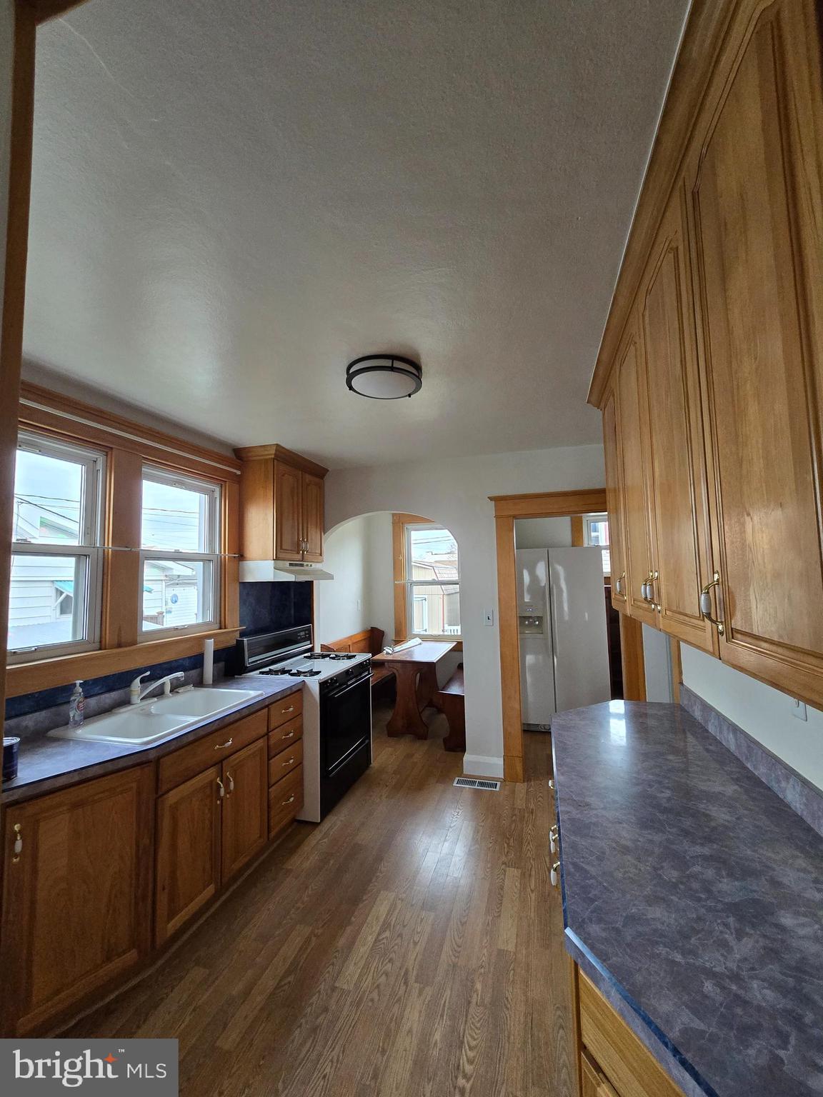 3015 Ritchie Avenue Baltimore, MD 21219 - Photo 6 of 17 a large kitchen with lots of counter top space and wooden floor