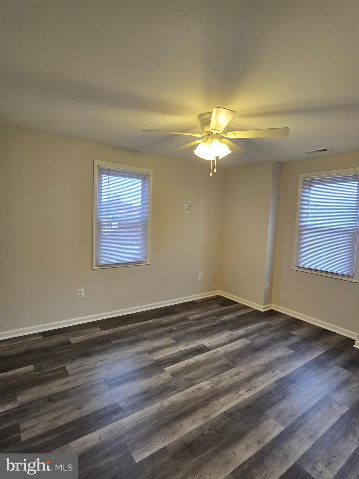 3015 Ritchie Avenue Baltimore, MD 21219 - Photo 10 of 17 a view of an empty room with wooden floor and a window