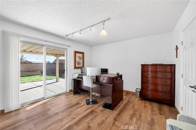 a view of a workspace with furniture and a window