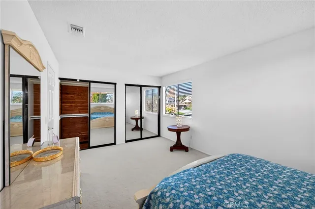 a bedroom with a bed and a table chair