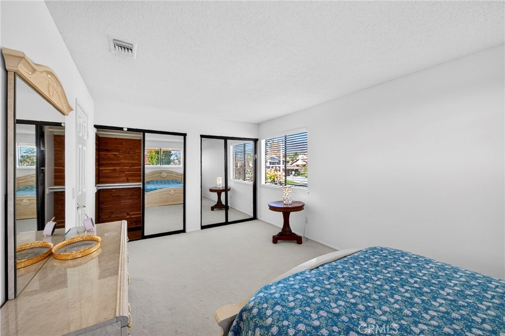 6109 Vineyard Avenue Rancho Cucamonga, CA 91701 - Photo 14 of 22 a bedroom with a bed and a table chair