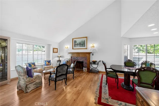 a living room with fireplace furniture and a large window