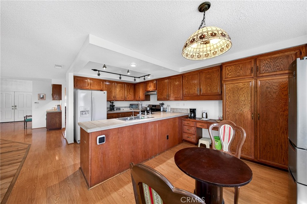 6109 Vineyard Avenue Rancho Cucamonga, CA 91701 - Photo 10 of 22 a kitchen with stainless steel appliances granite countertop a sink refrigerator stove and microwave