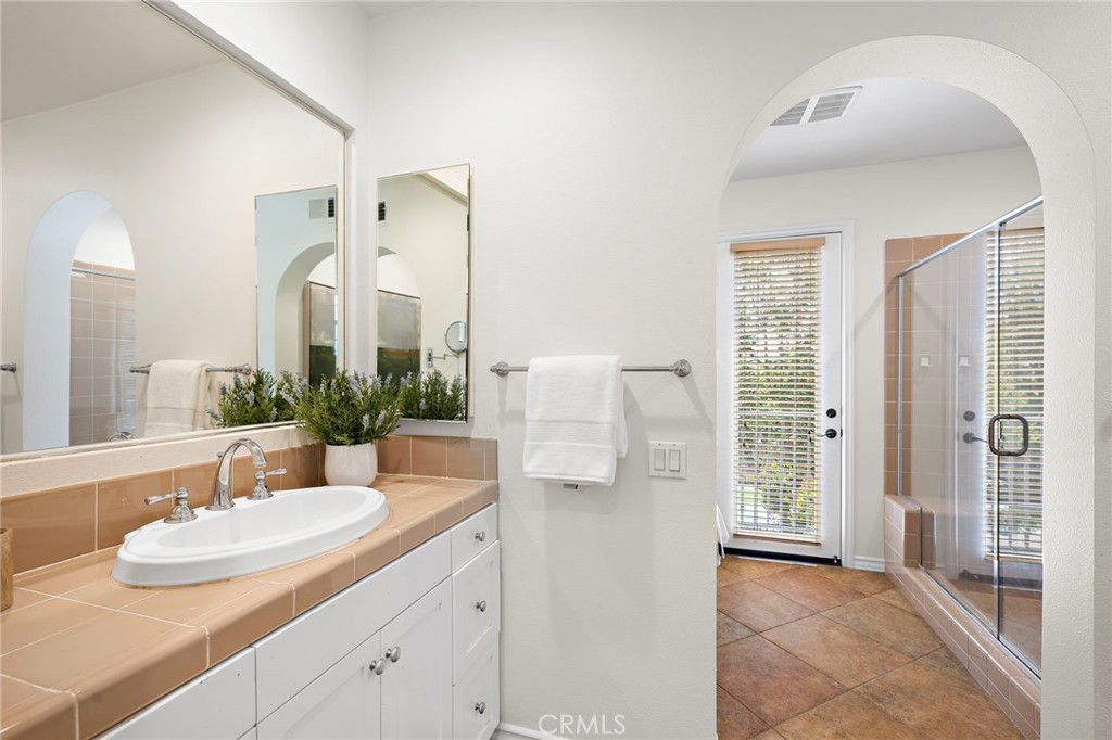 47 Tuscany Ladera Ranch, CA 92694 - Photo 14 of 28 a bathroom with a sink and a mirror